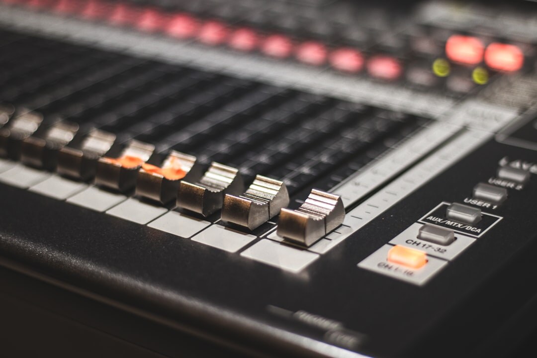 Audio mixing console with sliders in a sound studio